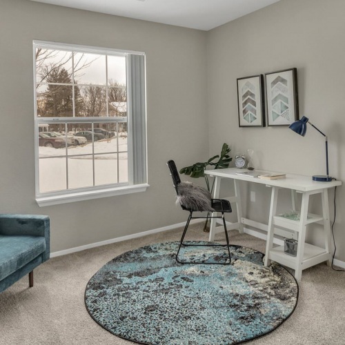 apartment workspace corner with windows and couc